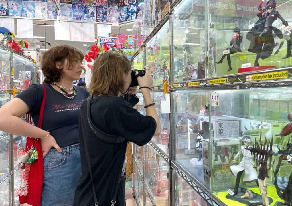 Tokyo-Akihabara-people checking out anime figures-landscape-1 (Exploring Akihabara: Living the Ultimate Otaku Dream)