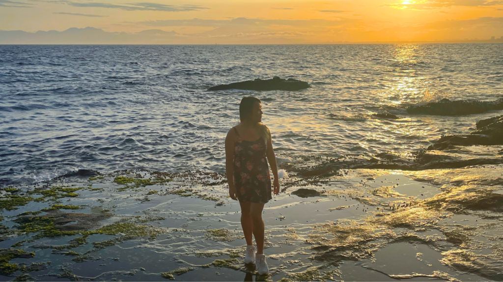 Flip Japan photo of Venese standing alone at sunset on the rockpools by Enoshima in Japan