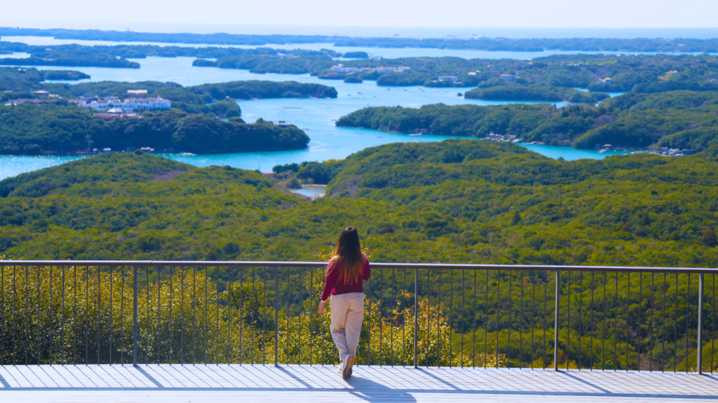 Flip Japan photo of Venese standing facing a bay of islands in Japan