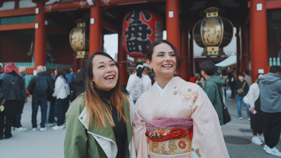 Flip Japan photo of two women at senso-ji, one in normal clothes, the other in kimono for the post What to Wear in Japan cover photo