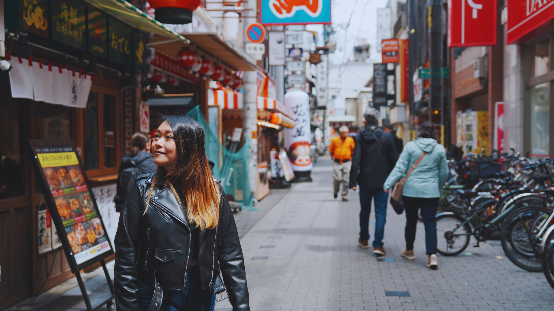 Flip Japan photo Osaka vs Tokyo vs Kyoto: Food Flip Japan photo of a woman in Dotonbori street market for Osaka vs Japan
