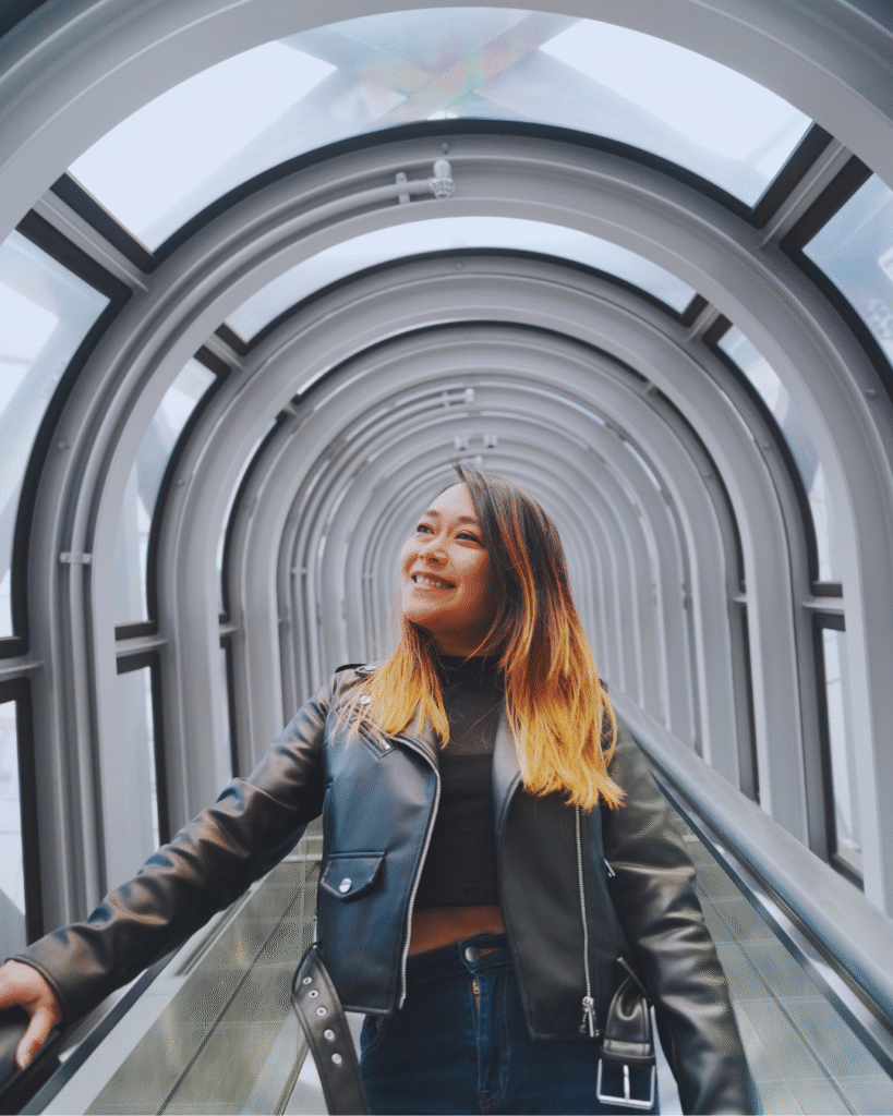 Flip Japan photo of a woman standing in the Umeda Sky Building escalator for Osaka vs Tokyo