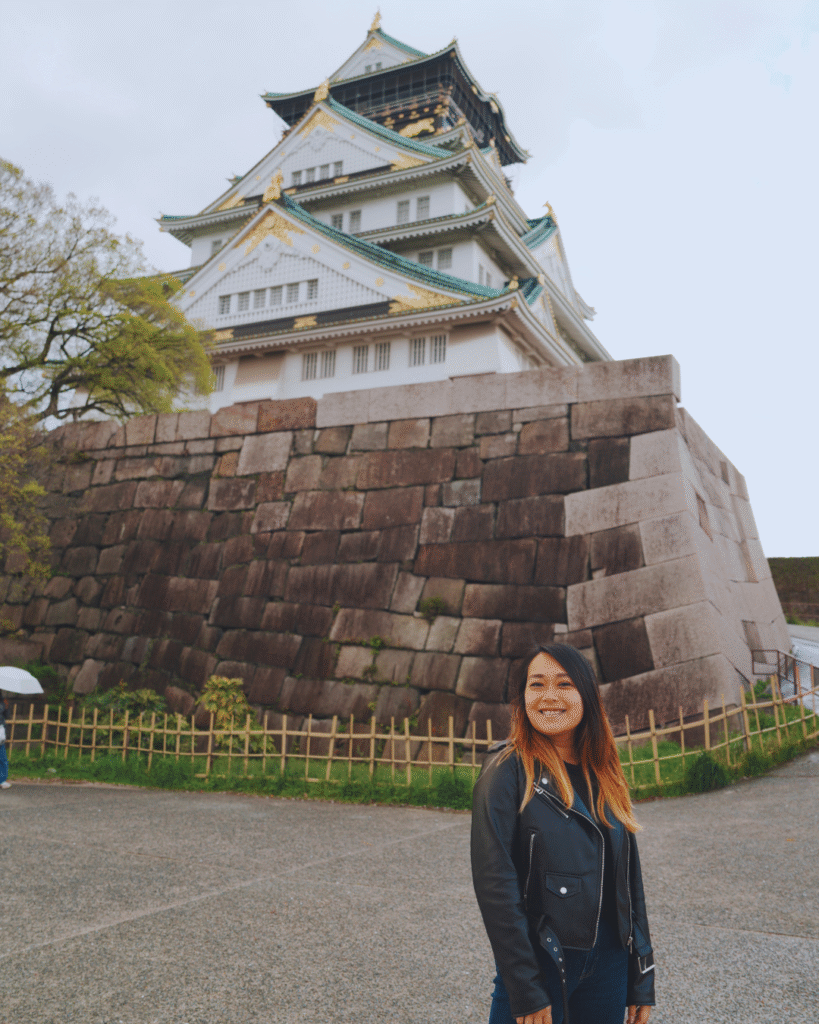 Flip Japan photo of a woman in front of Osaka castle for Osaka vs Tokyo vs Kyoto