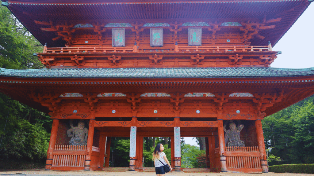 Flip Japan photo of a woman standing in front of Koyasan for how to get around Japan