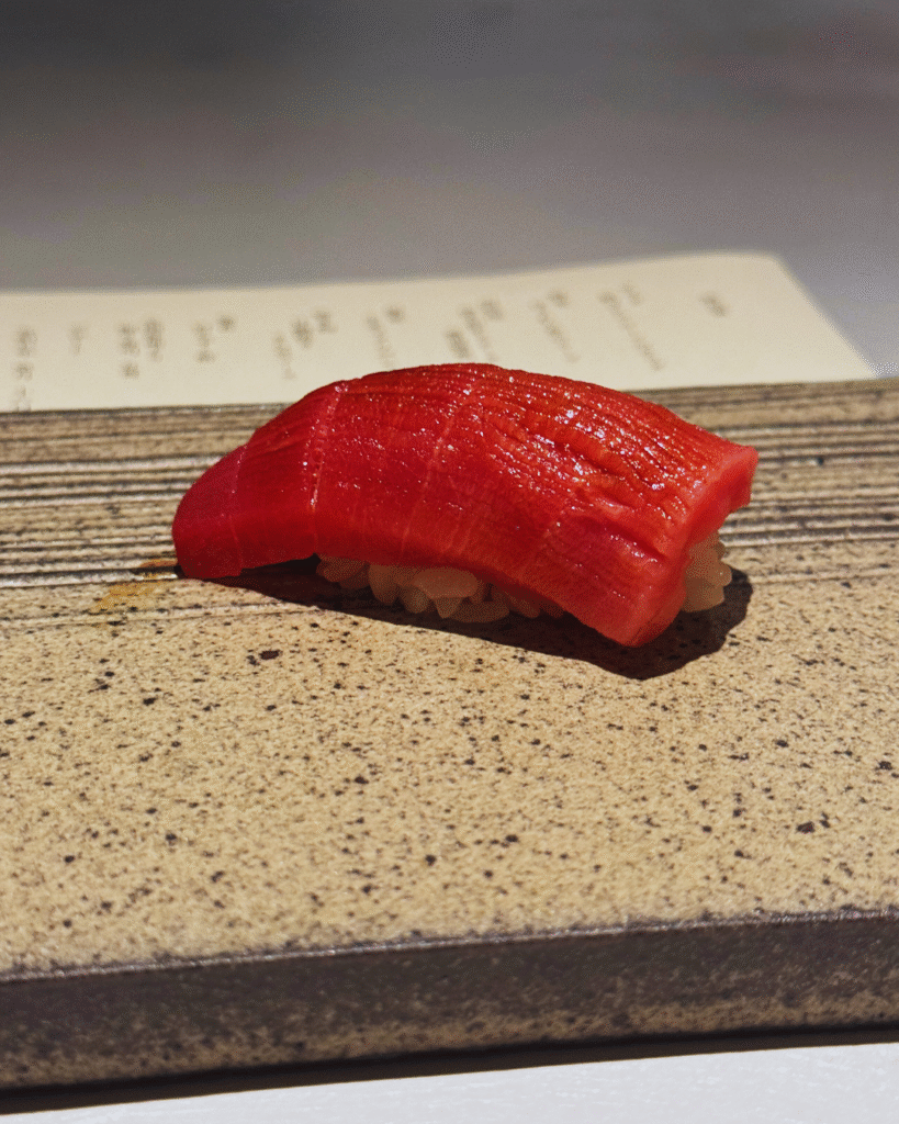 Flip Japan photo of a piece of tuna nigiri in foodie Japan