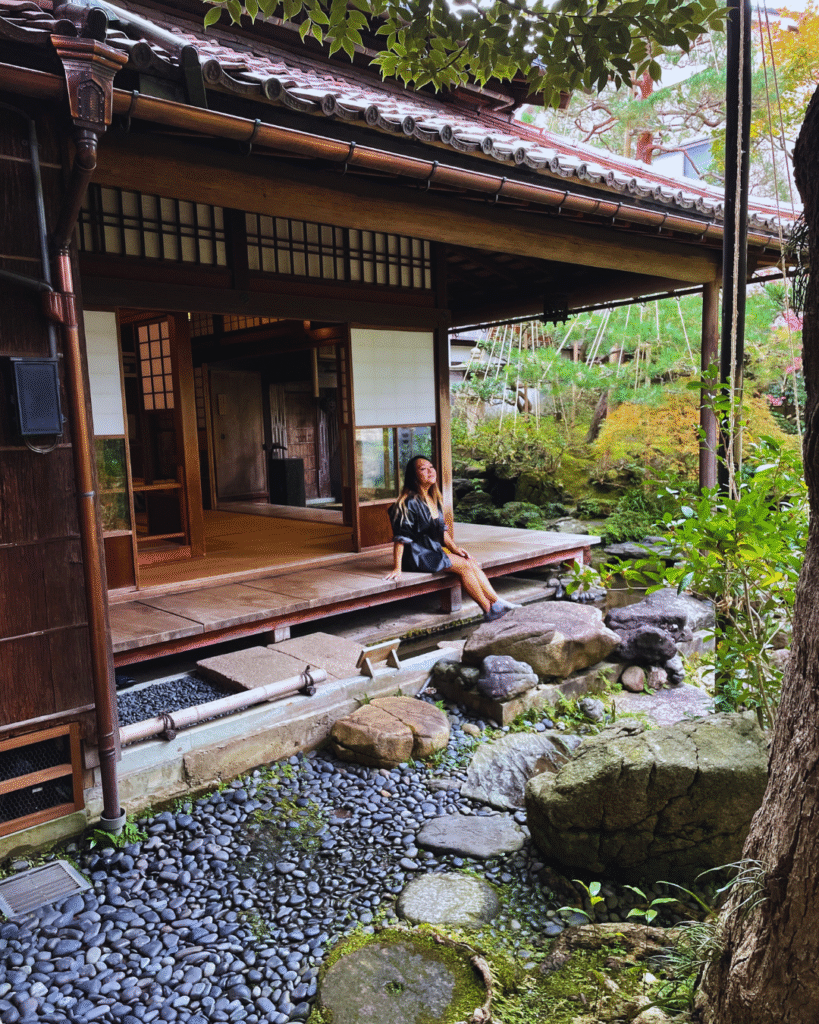 Flip Japan photo of a woman sitting on front of a wooden tea house in Kanagawa, a small city in Japan