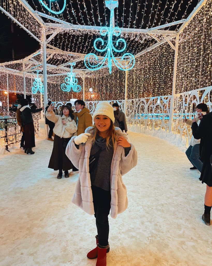 Flip Japan photo of a woman wearing a hat, scarf, and coat in the snow in winter in Japan