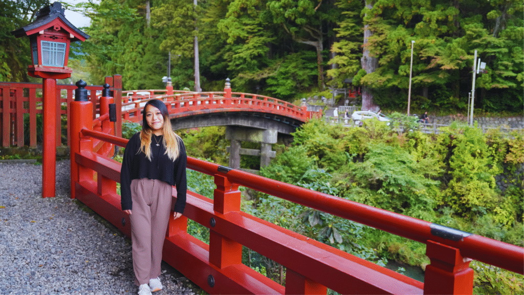 Flip Japan photo of a woman standing in front of Shinkyo bridge in Nikko