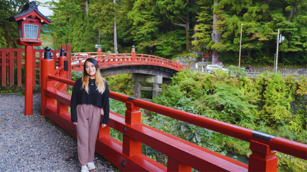 Flip Japan photo of a woman standing in front of Shinkyo bridge in Nikko