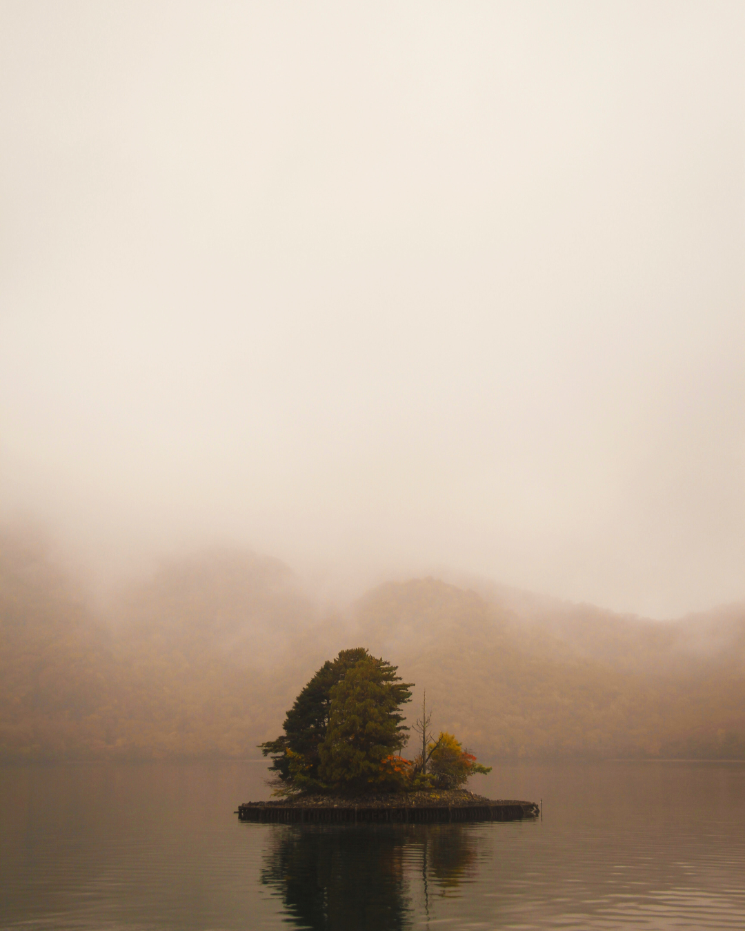 Photo of a misty view over Lake Chuzenji at sunset