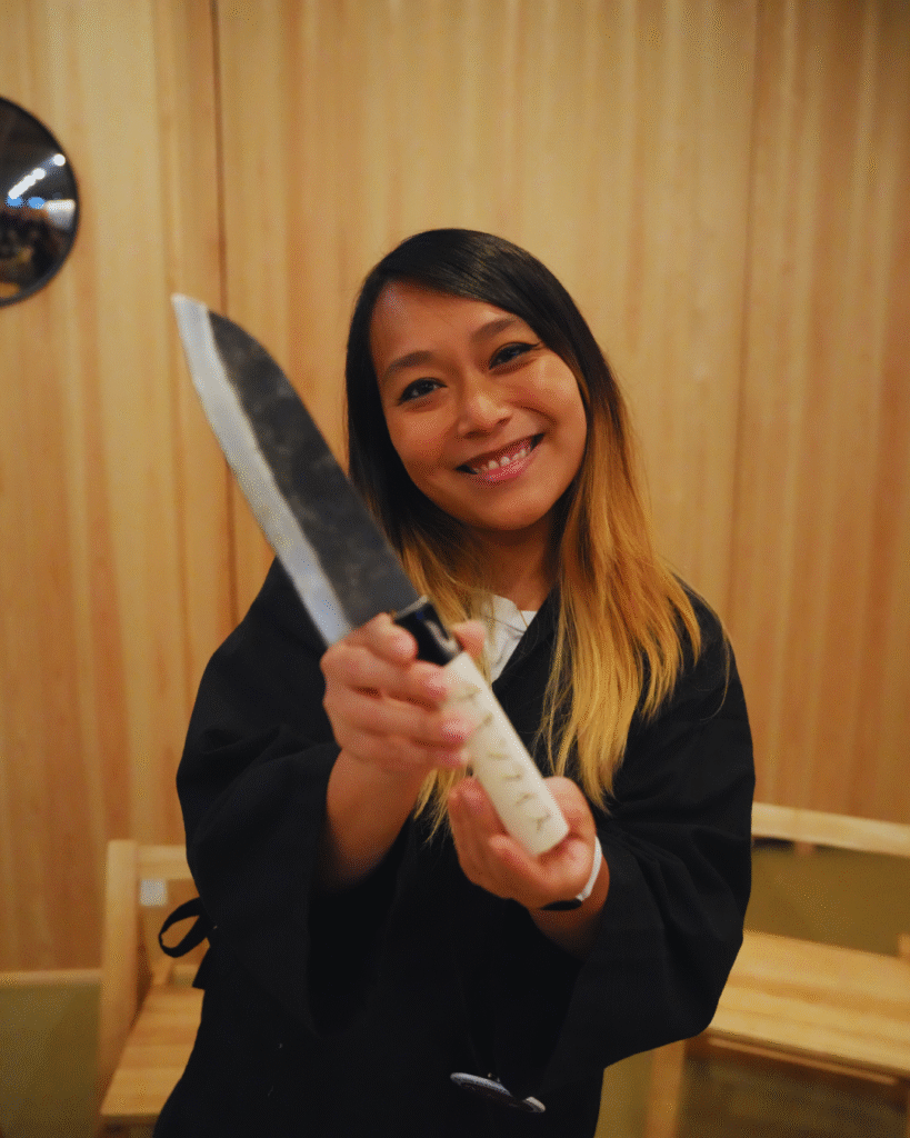Flip Japan photo of a woman holding a handmade knife as a cultural experience in Japan