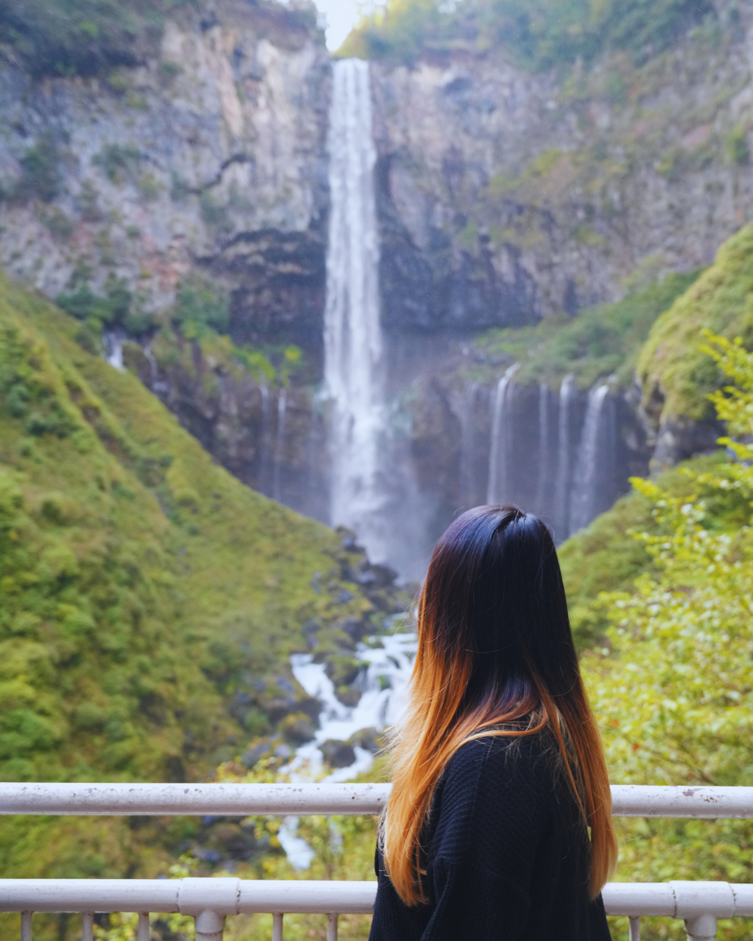 Flip Japan photo of a woman looking at Kegon Falls in Nikko