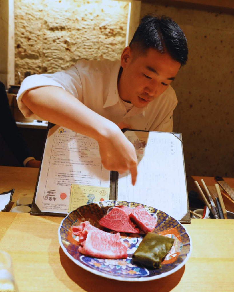 Flip Japan photo of a chef presenting a plate of kobe beef with its certificate
