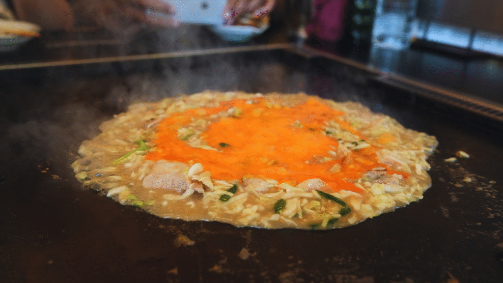Flip Japan photo of monjayaki being cooked on a grill for the Tokyo food guide