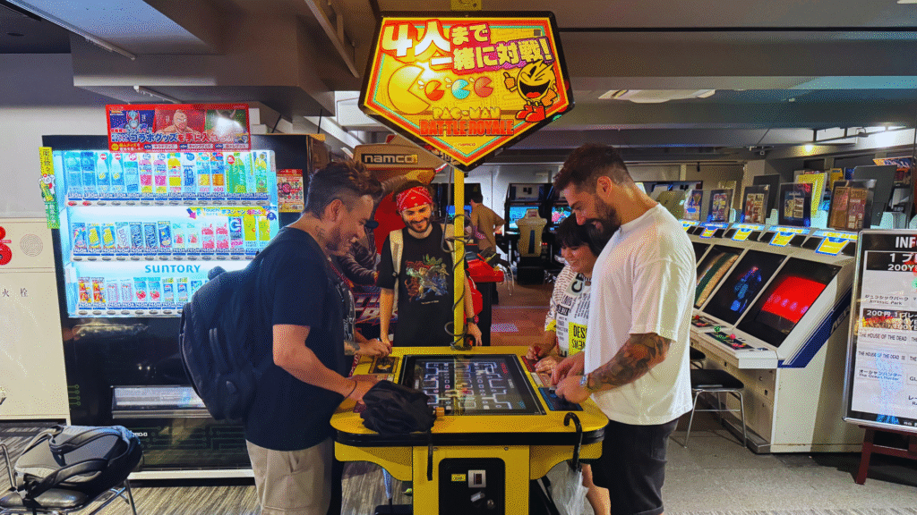 Flip Japan photo of a group of people playing an arcade game as part of pop culture in Japan