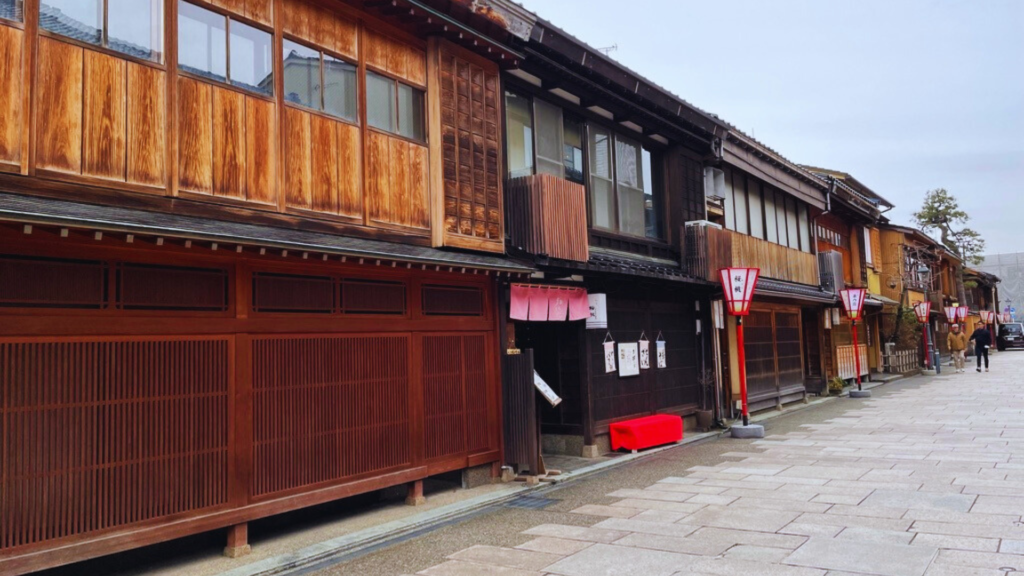 Flip Japan photo of a street in Nishi Chaya District, Kanazawa, with wooden buildings with wooden latices on the front