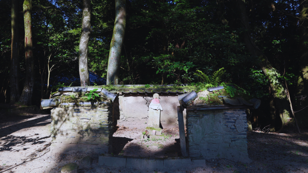 Flip Japan photo of a stone Jizo Bodhisattv statue in a red hood in Engyo Ji