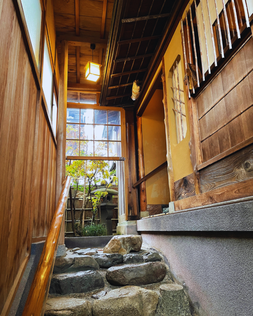 Flip Japan photo of a traditional wooden building with stone steps leading up to it in Kanazawa