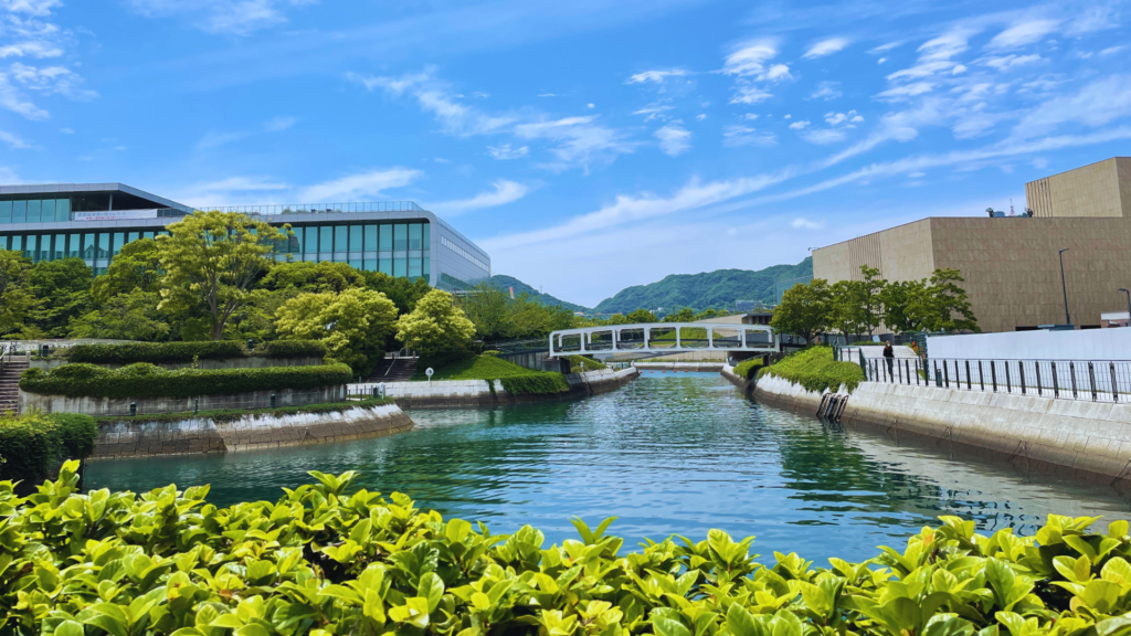 Flip Japan photo of a river, bridge, and scenery of Nagasaki