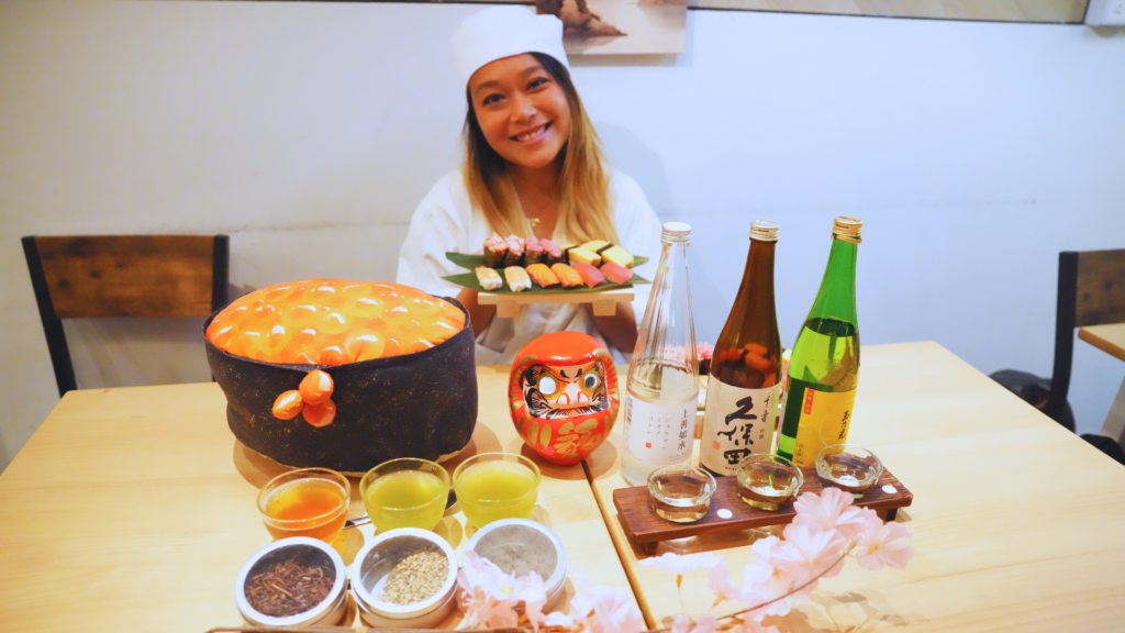 Flip Japan photo of Venese holding the plate of handmade sushi at the end of a sushi making class