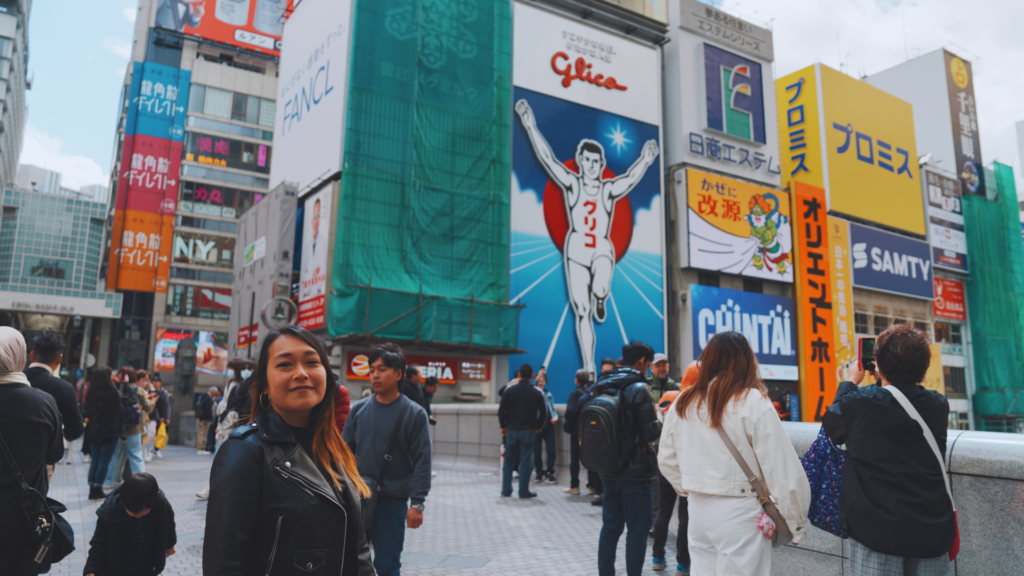 Flip Japan photo of Venese in front of the Glico Running Man sign in Dotonbori