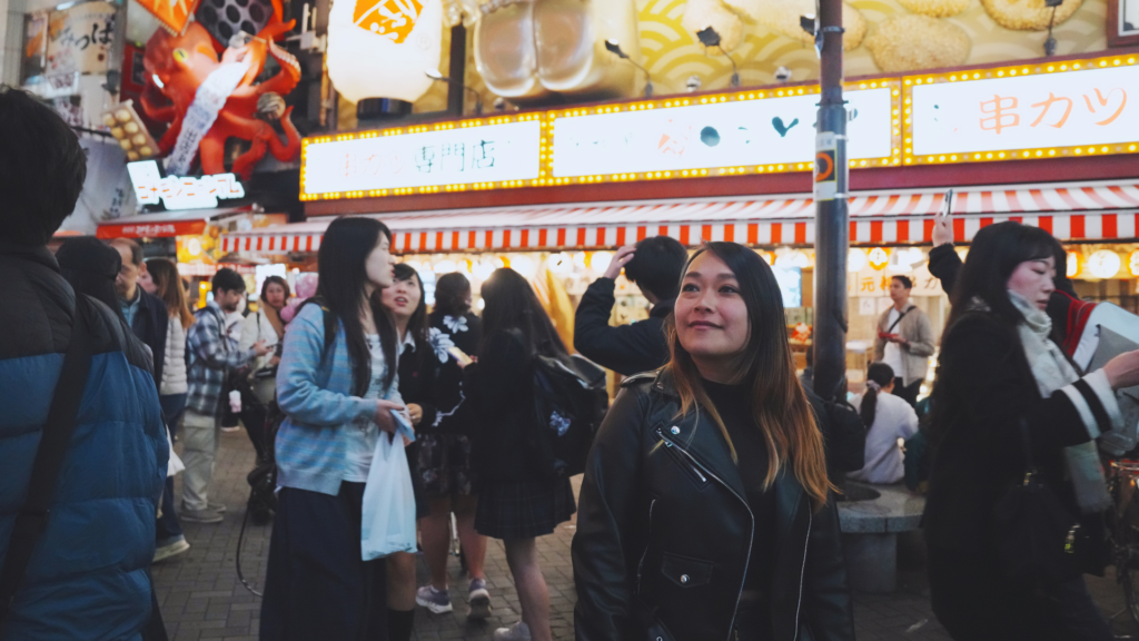 Flip Japan photo of Venese walking through Dotonbori at night