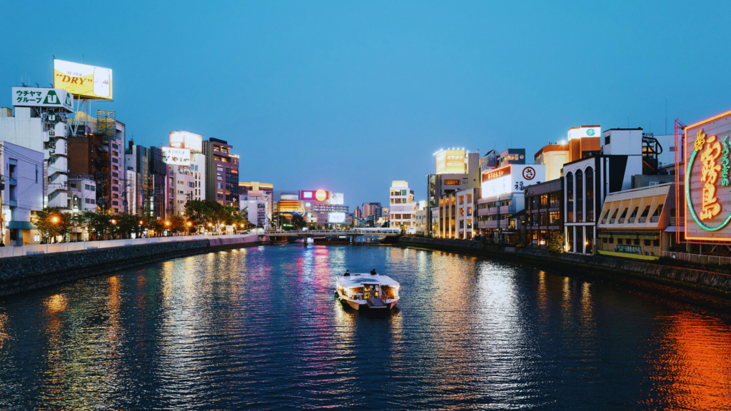 Photo of a river running through Fukuoka at dusk