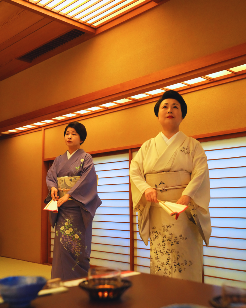 Flip Japan photo of two women in kimono demonstrating geisha practices for a MICE tourism in Japan group