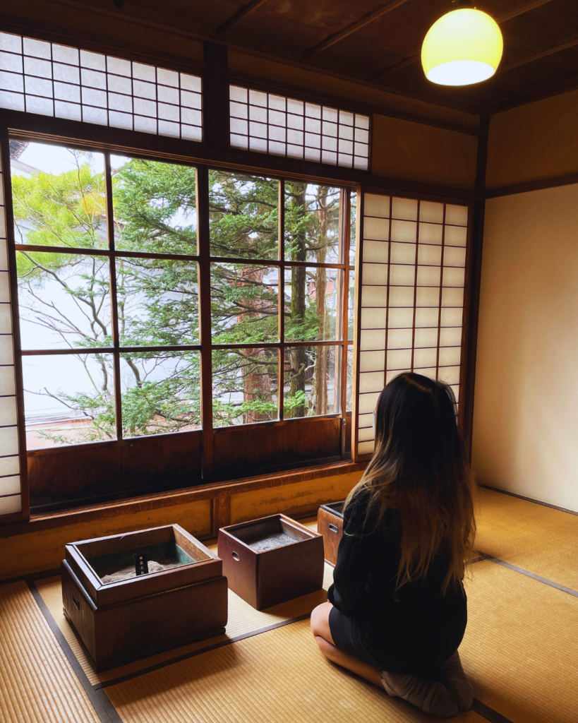 Flip Japan photo of Venese kneeling on a tatami floor by a window in Takayama Jinya for MICE venues in Japan