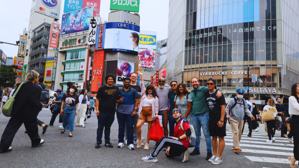 Flip Japan photo of a team on a group trip for MICE Tourism in Japan standing under a torii gate in Shinjuku