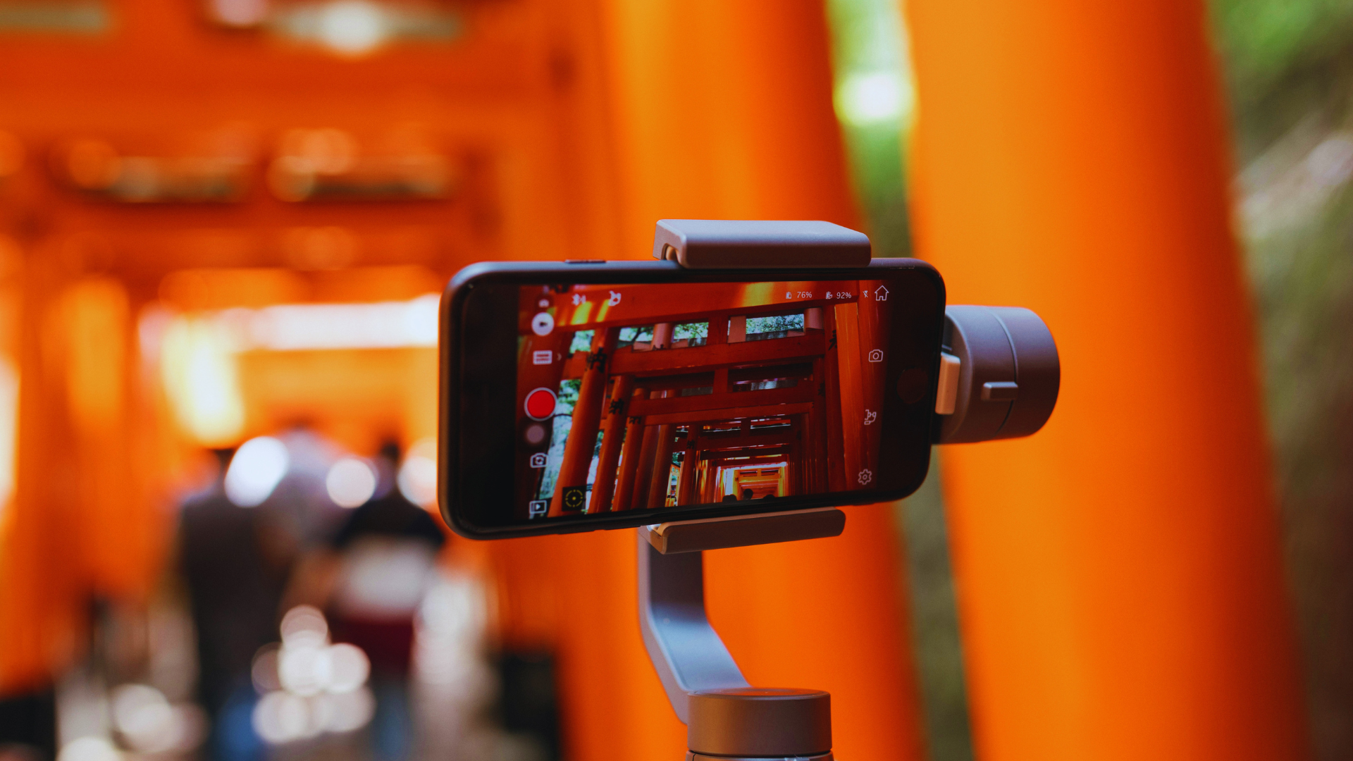 A photo of a phone on a tripod in Fushimi Inari filming in Japan