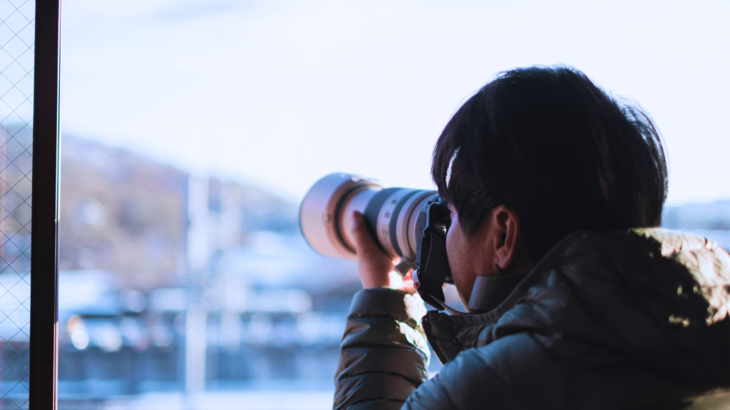 Image of a man taking a photo of a mountain in Japan