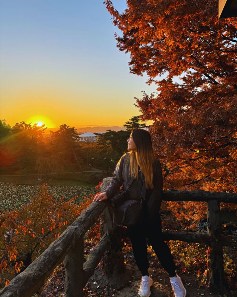 Flip Japan photo of Venese standing at Hirosaki Castle at sunset