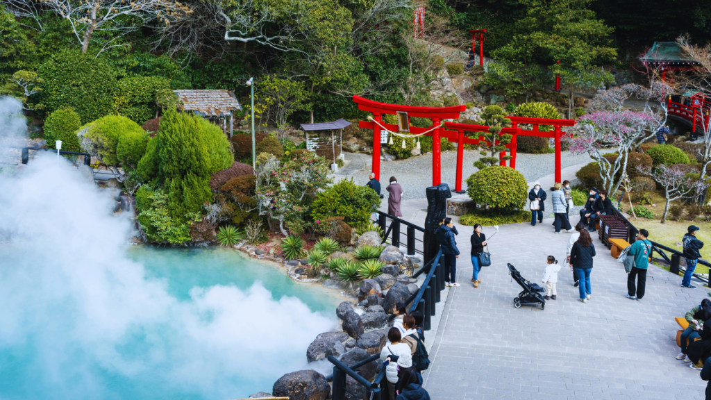Photo of a red torii gate in Japan next to the steamy onsen in Beppu