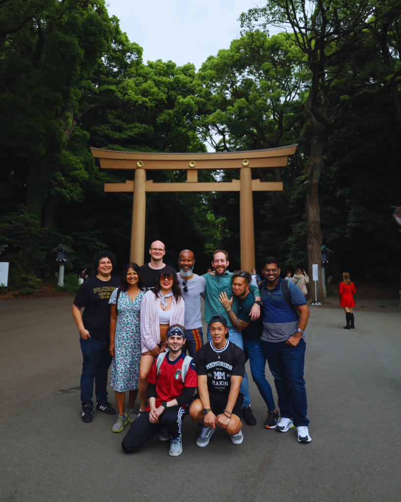 Flip Japan photo of a tour group in front of a giant wooden torii gat in Meiji Jingu, Tokyo