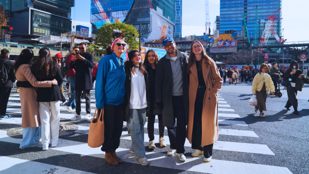 Flip Japan photo of a tour group posing in the middle of Shibuya Crossing