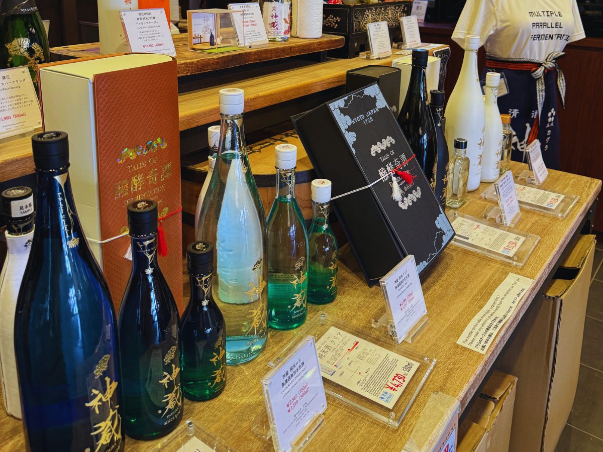 Sake bottles lined up on a counter at a sake tasting experience in Tokyo.