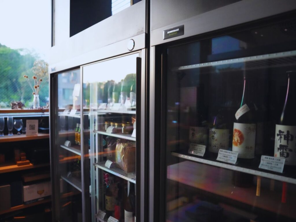 A refrigerator holds several bottles of sake at a sake tasting in Tokyo. Its one of the Sake Experiences You Should Try to Taste and Understand Japan's National Drink.