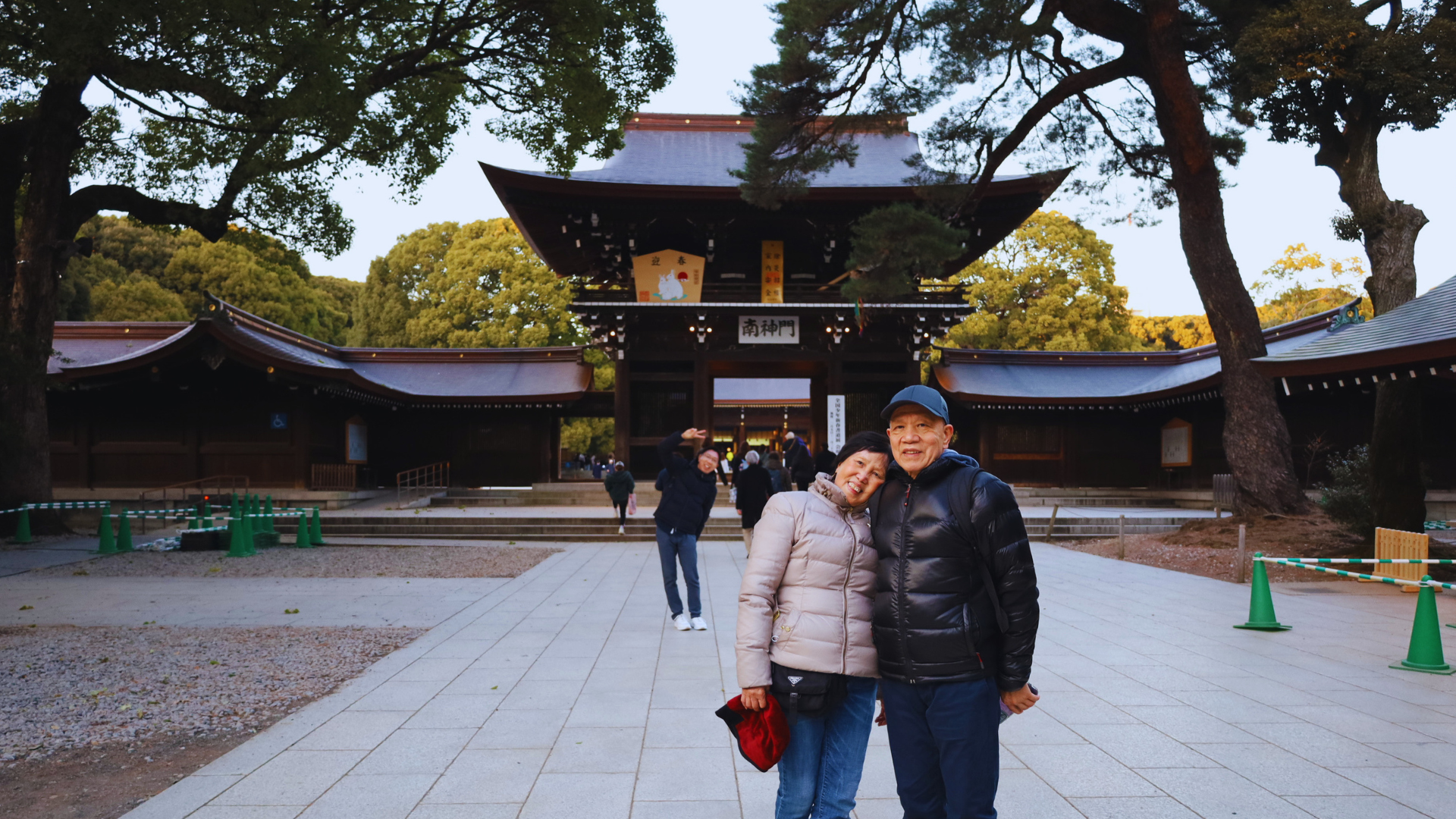 Flip Japan Retirement Trip Itineraries Guide: Nature-focused Tokyo Flip Japan photo of a senior couple posing outside of meiji jingu in Tokyo