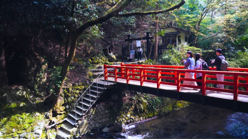 Flip Japan photo of the hike from Kifune to Kurama with a red bridge and steps down  on a mountainside