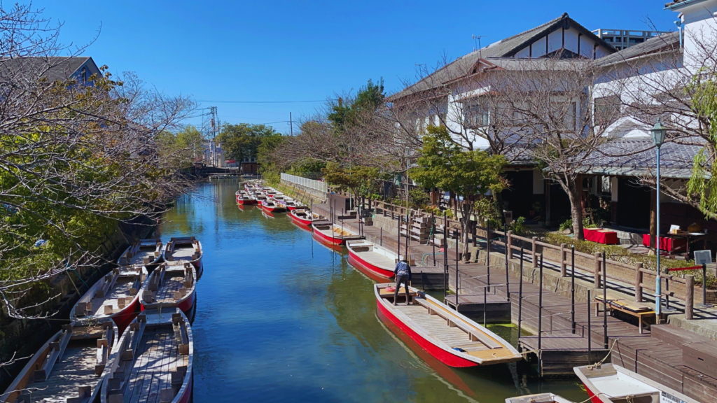 Flip Japan photo of the view of a canal with boats from a bridge in Yanagawa, one of the best Fukuoka day trips