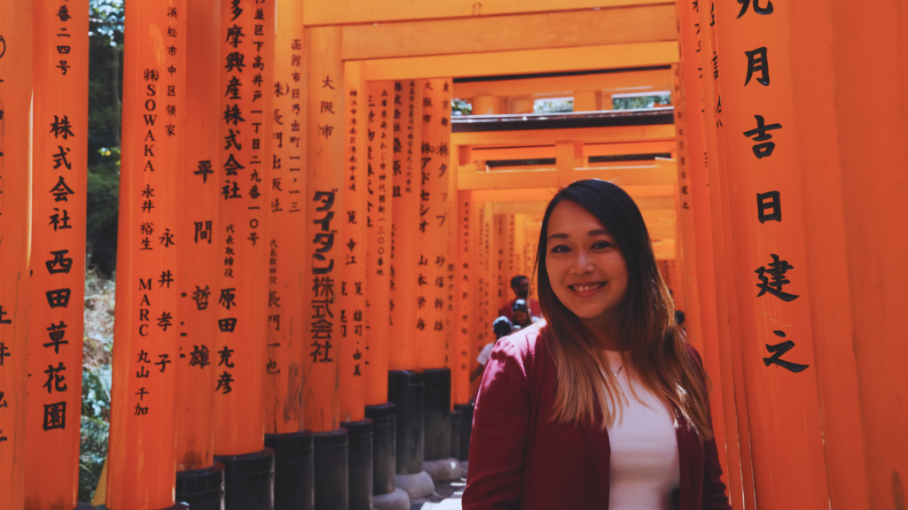 Flip Japan photo of Venese standing under the torii gates in Fushimi Inari