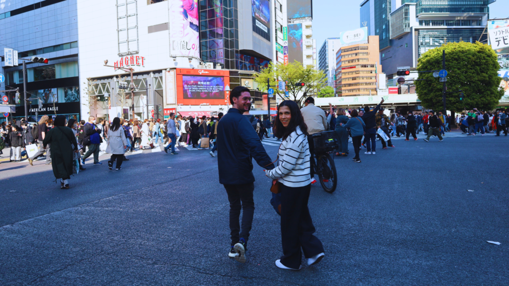 Flip Japan photo of a couple holding hands and walking through Shinjuku