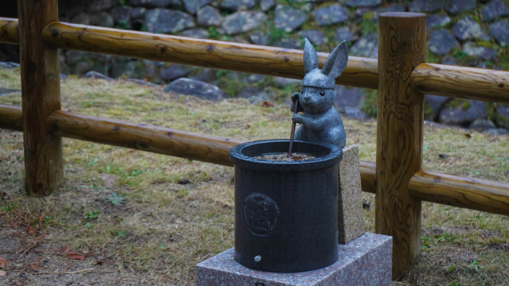 A photo of a statue of a rabbit pounding mochi