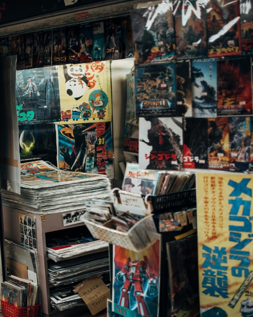 Vintage showa era posters are set up in the room with more stacked along the foor.