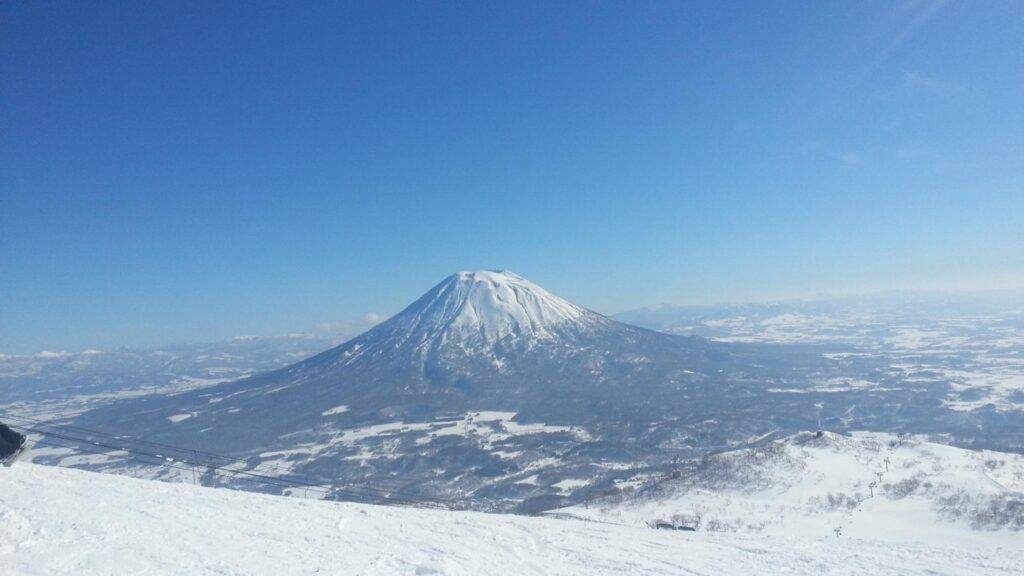 Mt Yotei under a clear blue sky, seen from the Niseko slopes, one of the best views for things to do in Niseko besides skiing